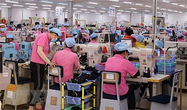 Employees work at shoe factory for exports at Vinh Hoa Hung Nam Industrial Zone in Kien Giang province’s Go Quao district. Photo: VNA