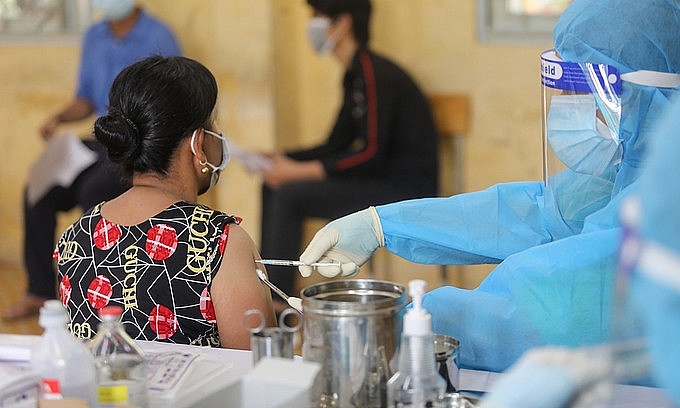 A woman receives a Covid-19 vaccine shot in HCMC's Thu Duc City, August 15, 2021. Photo: VnExpress