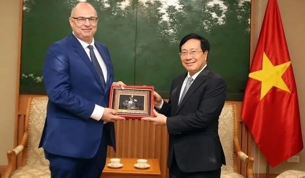 Permanent Deputy Prime Minister Pham Binh Minh (right) hosts a reception for outgoing Ambassador of Denmark Højlund Christensen on July 5. Photo: VGP