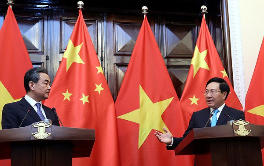 Deputy Prime Minister Pham Minh Minh (R) welcomes Chinese State Councilor cum Foreign Minister Wang Yi in Hanoi in 2018. The two officials are scheduled to co-chair the 14th meeting of the steering committee for bilateral cooperation in Naning during Minh's visit on July 12-13. Illustrative photo: VGP