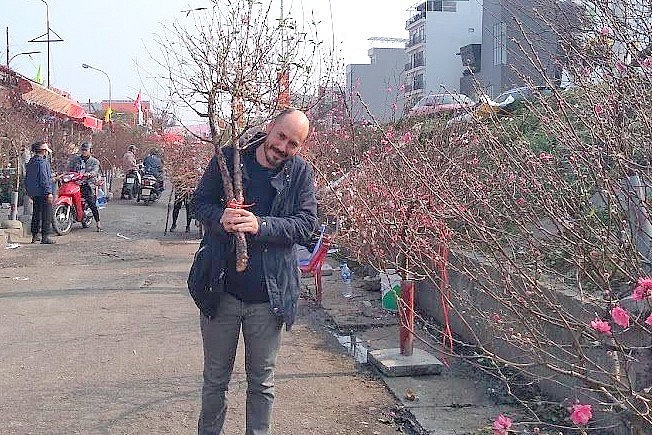 Daniel celebrates Vietnamese New Year with a branch of Nhat Tan peach.