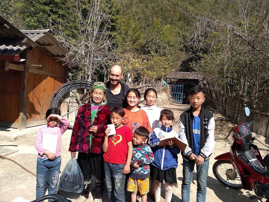 Daniel Blanco with locals on a field trip in Vietnam.