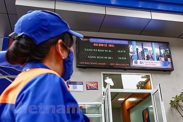 A Petrolimex gas station prepares for the listing of new petrol prices. Photo: VNA