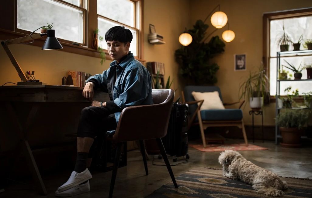Ocean Vuong at home with his dog, Tofu. Photo by Aram Boghosian via LA Times.