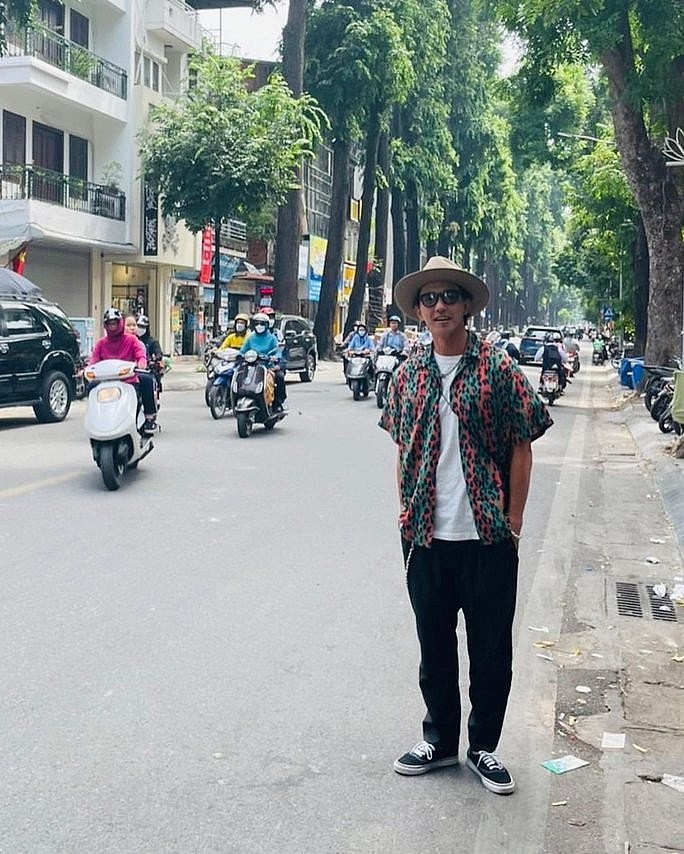 Noboru Kaneko walking the streets of Hanoi.  Photo: NLD