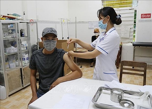 A man gets vaccinated against Covid-19 in Vietnam. Source: VNA