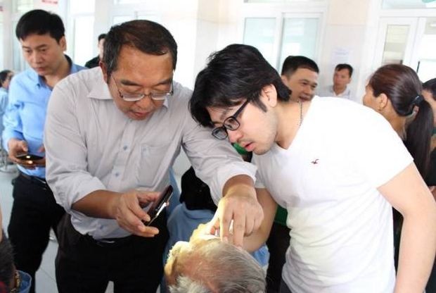 Japanese ophthalmologist Tadashi Hattori (L) treats a patient in Vietnam in this undated handout photo provided by the Ramon Magsaysay Award Foundation, Aug. 31, 2022.