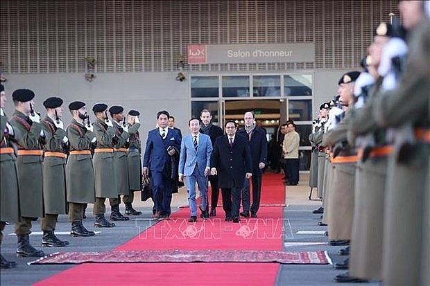 Prime Minister Pham Minh Chinh (right, first line) at Luxembourg-Findel international airport. Photo: VNA