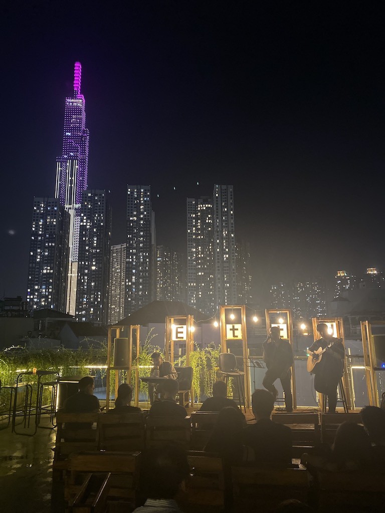The band plays on the rooftop of District 3, Ho Chi Minh City, behind is the city's Landmark 81 symbol ( taken by Nhung Nguyen).