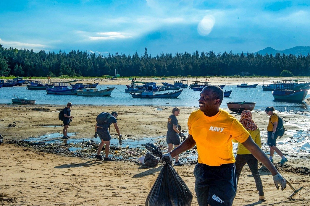 Members of the US Navy, Royal Navy, Australian Defence Force, and Vietnamese volunteers participate in a clean-up session at Vung Lam Beach during Pacific Partnership 2022. Source: US embassy in Vietnam