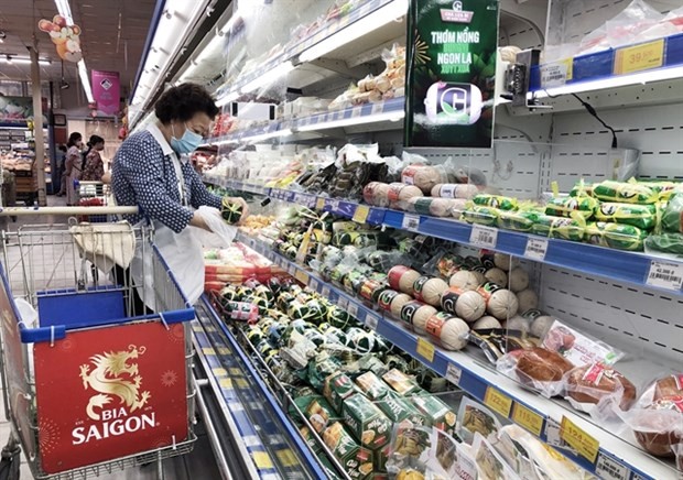 Customers buy food at a supermarket in HCM City. Photo: VNA