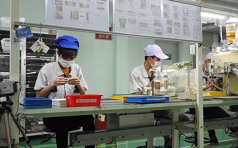 Workers assemble products at Vietnam Tabuchi Electric in Bac Ninh Province.