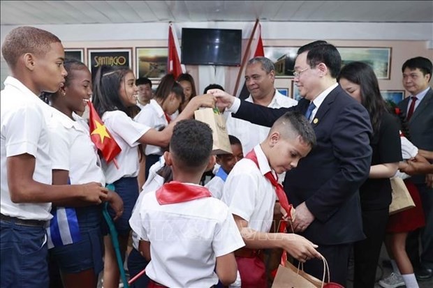 NA Chairman Vuong Dinh Hue presents gifts to students of Cuba-Vietnam Friendship School. Photo: VNA
