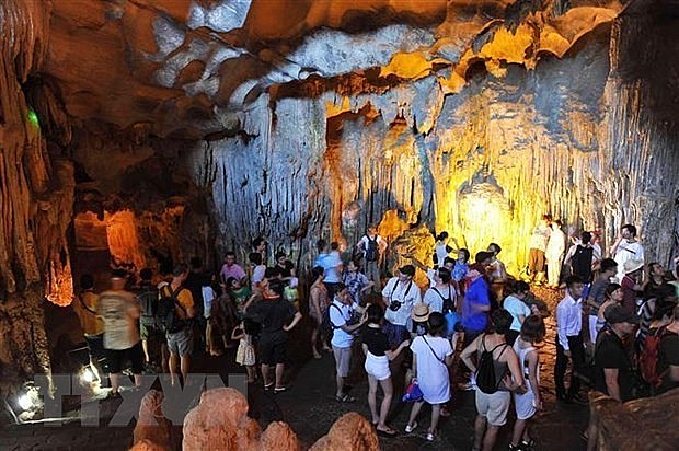 Tourists visit a cave in Ha Long Bay in the northeastern province of Quang Ninh. (Photo: VNA)