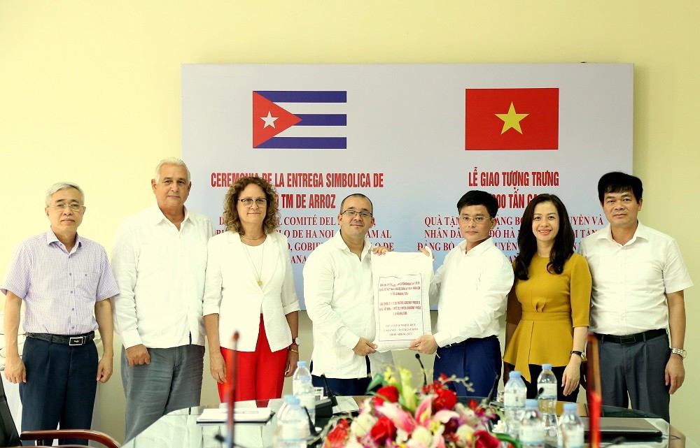 Deputy Director of Hanoi Department of Finance Mai Cong Quyen and Deputy Embassy of Cuba in Vietnam Joy Puentes Saldies, and delegates performed the symbolic rice-giving ceremony. Photo: Van Truong