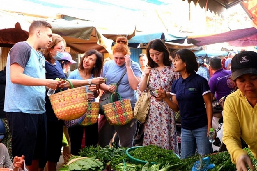 Foreign tourists go shopping at a traditonal market in Vietnam. (Photo: Cong Binh/Dan tri)
