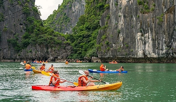 Tourists go kayaking on Ha Long Bay in the northern province of Quang Ninh province.  (Photo: quangninh.vn)