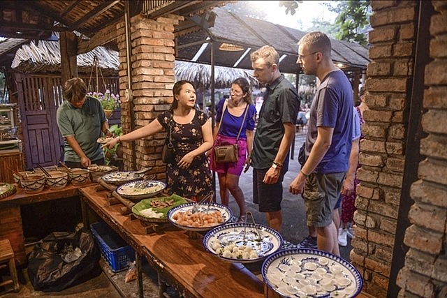 A group of foreign tourists visit Bình Quới tourism village in Bình Thạnh District. Photo tuoitre.vn
