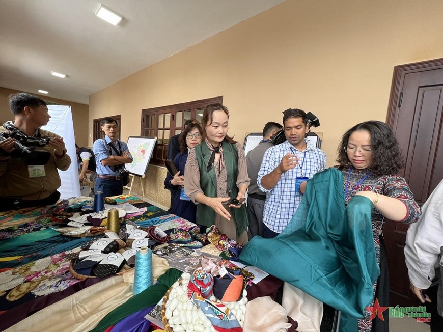 Indian businesses visit a booth to introduce Lam Dong silk products.