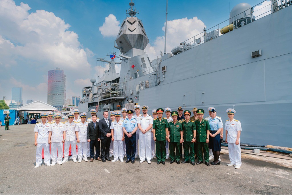 Representatives from Vietnam’s Navy Region 2, Commander Indo Pacific Endeavour, Commanding Officer HMAS Toowoomba and Australian Defence Staff stand alongside HMAS Toowoomba after arriving in Ho Chi Minh City