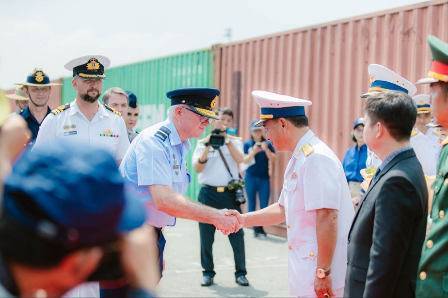 Commander Indo Pacific Endeavour, Air Commodore Tony McCormack, is welcomed by Deputy Chief of Staff Navy Region 2 Senior Captain Nguyen Việt Anh on the wharf in Ho Chi Minh City