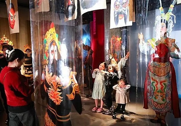 Visitors at the exhibition introducing tuong (classical drama). (Source: VNA)
