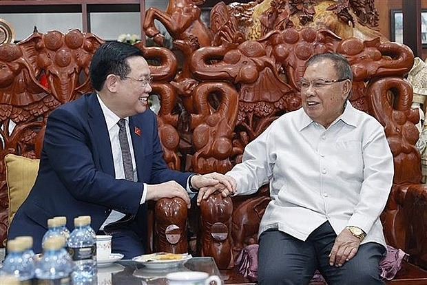 NA Chairman Vuong Dinh Hue (L) and former Lao Party General Secretary and President Bounnhang Vorachith (Photo: VNA)