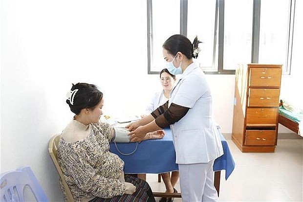 Medical workers at Xaysomboun hospital provide medical examination to a local woman. (Photo: VNA)