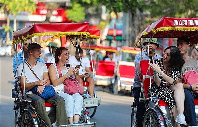Tourists on cyclos visiting Hoàn Kiếm Lake in Hà Nội. The total revenue from tourism in 2024 is estimated to reach around VND840 trillion (US$34.4 billion). 