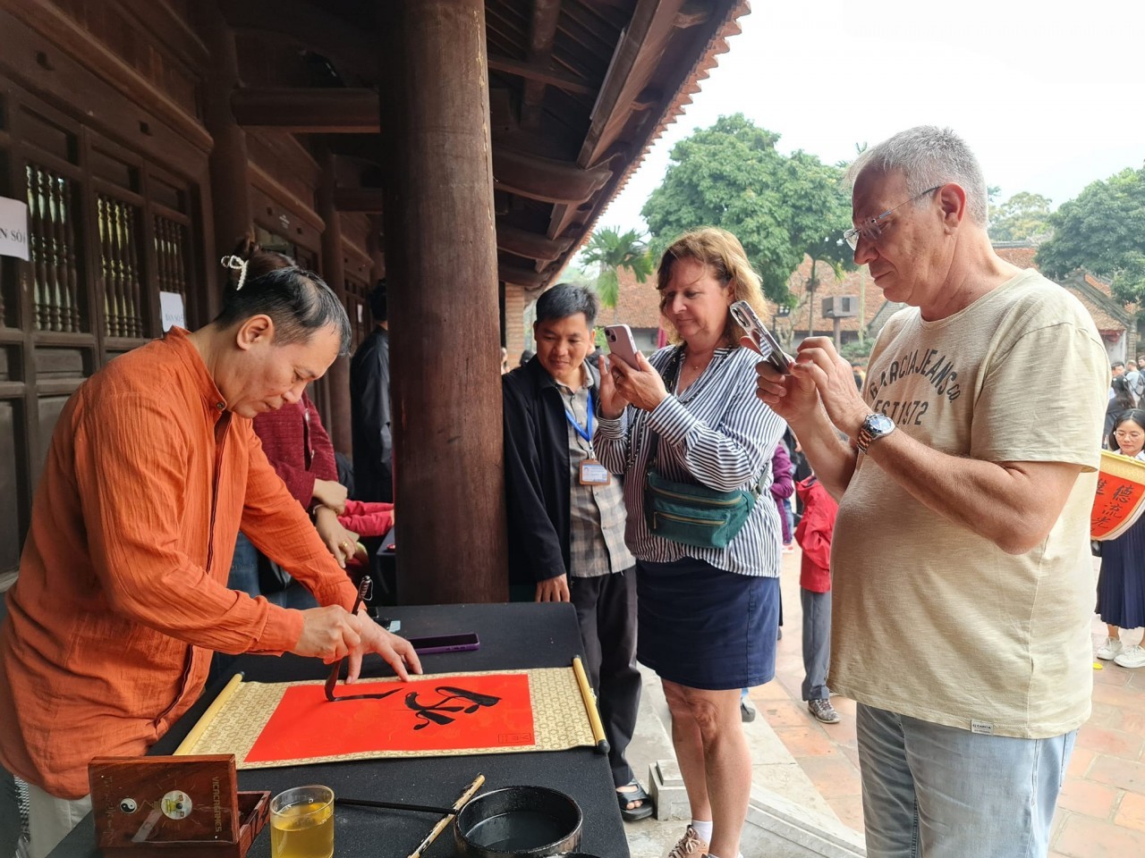 international tourists ask for calligraphic works at temple of literature