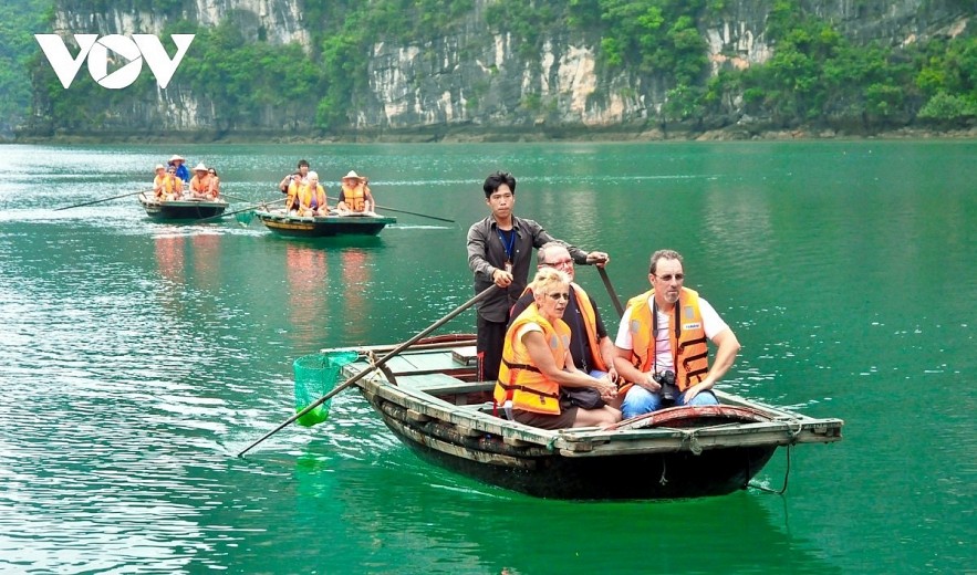 Foreign visitors make a tour of Ha Long Bay, a UNESCO heritage site in Vietnam