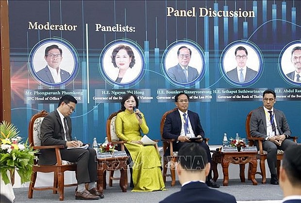 Governor of the State Bank of Vietnam Nguyen Thi Hong  (second, left ) speaks at the event. (Photo: VNA)
