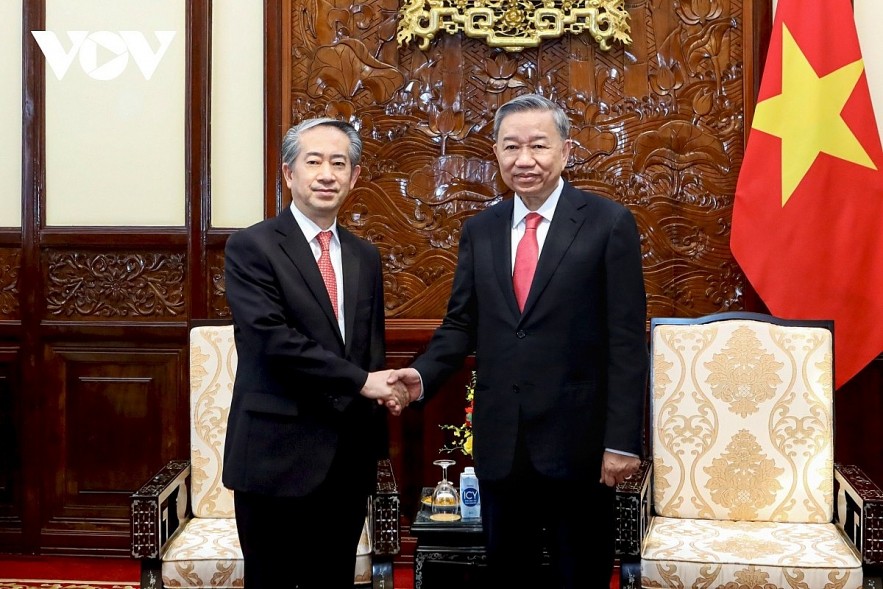 Newly elected President To Lam (R) shaking hands with Chinese Ambassador to Vietnam ahead of their meeting in Hanoi on June 11