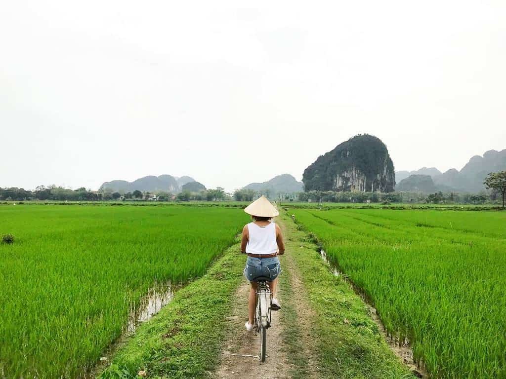 Tourists enjoying the peaceful surroundings during a Vietnam bike tour (Source: Collected)