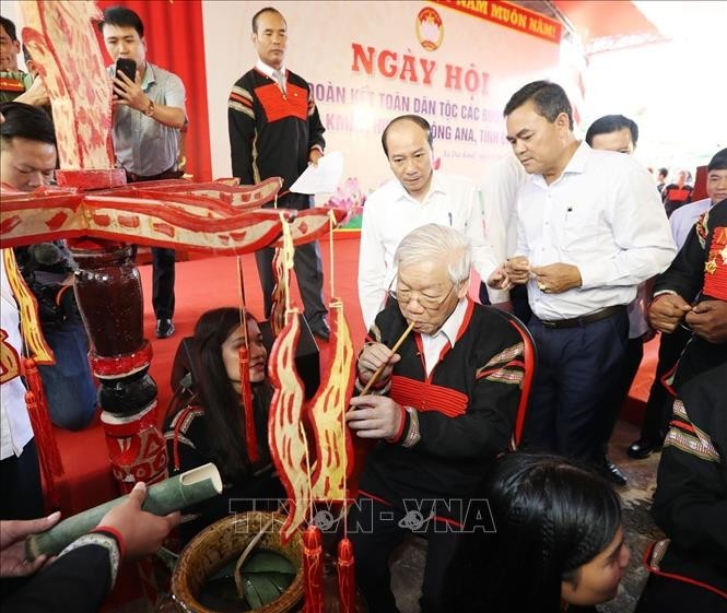 General Secretary and State President Nguyen Phu Trong drinking traditional wine with the ethnic people of Dur Kmal commune, Krong Ana district, Dak Lak province during the Great National Unity Festival in November 2018. (Photo: VNA)