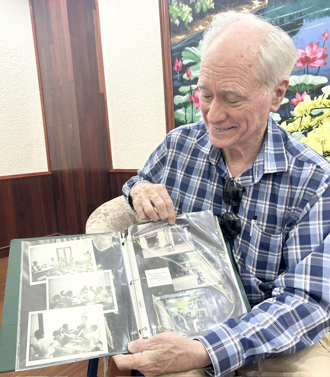 Dick Hughes always carries an album of photos of the street children he once cared for whenever he returns to Vietnam.