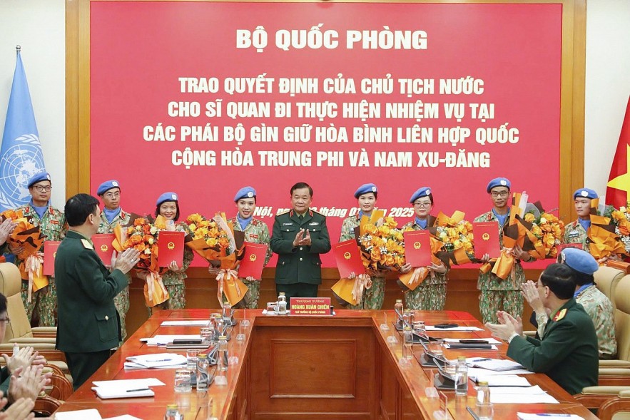 Lieutenant General Hoang Xuan Chien, Deputy Minister of National Defense, congratulates the eight officers. Photo: Thuy Linh