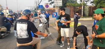 Foreigners Distribute Bottled Water to Tet Travelers