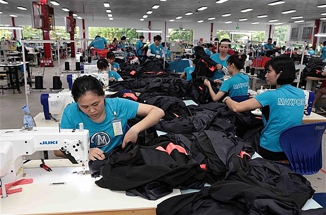 Producing apparel for export at a factory in Nam Dinh Province. Photo: VNS