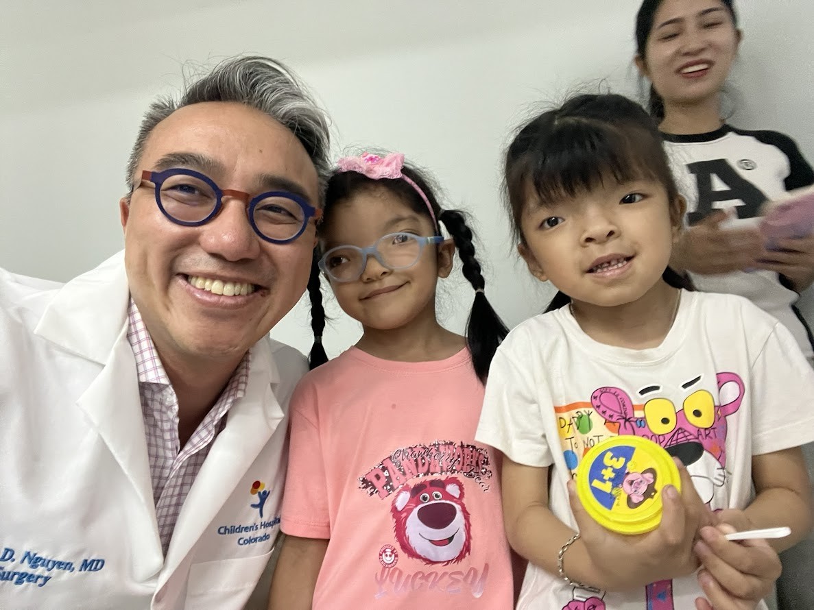 Dr. Phuong Nguyen (far left), Co-founder, Medical Director of NUOY, takes a photo with a young patient. (Photo: NUOY)