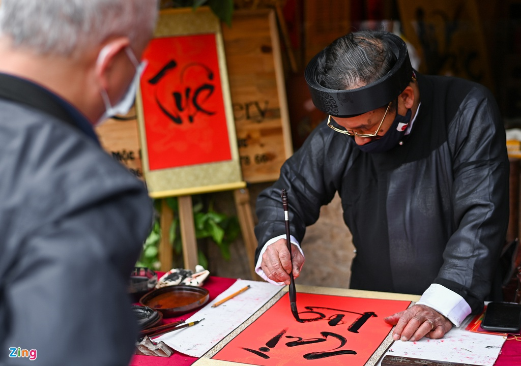 calligraphers wear face masks give words in temple of literature