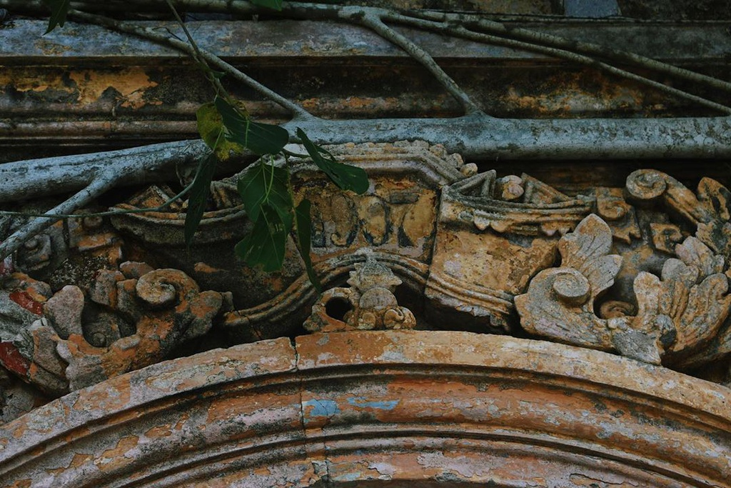 unique centenarian communal house embraced by bodhi tree roots in vietnams mekong delta