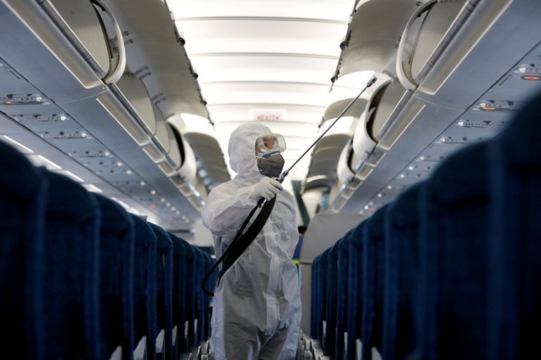 A health worker sprays disinfectant inside a Vietnam Airlines airplane to protect from the recent coronavirus outbreak, at Noi Bai airport in Hanoi, Vietnam February 21, 2020. (Photo: Reuters)