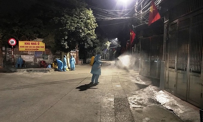 Medical workers disinfect a neighborhood in the northern quang ninh province after person was confirmed infected with covid-19, january 27, 2021. 