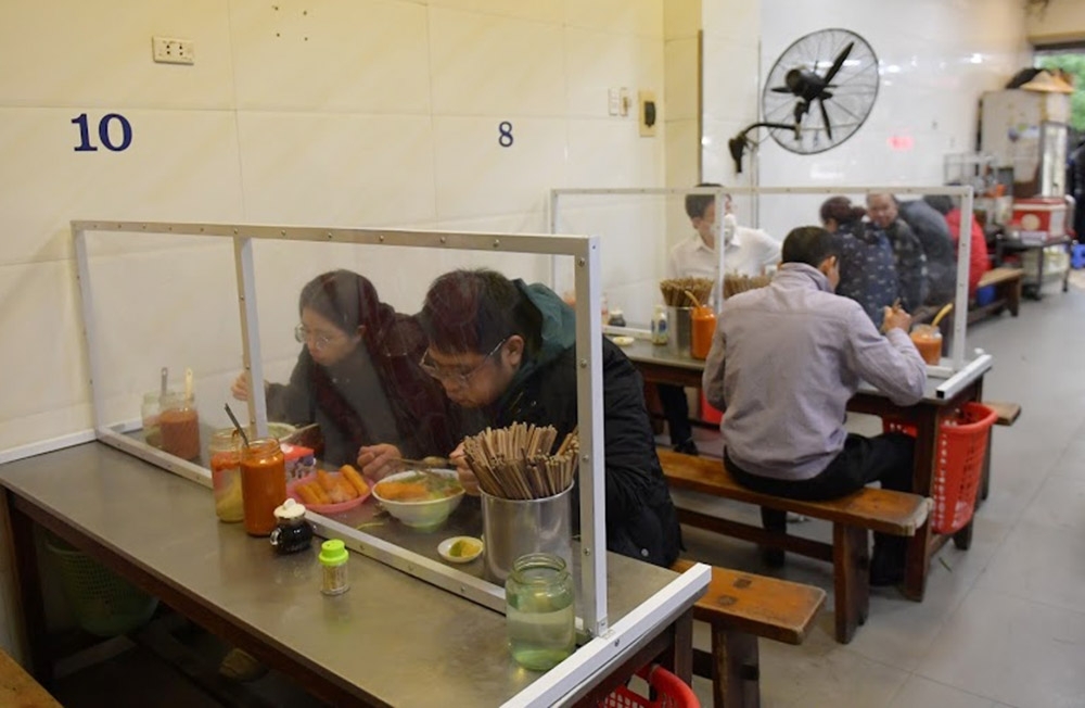 hanoi restaurants install table partitions to curb covid 19