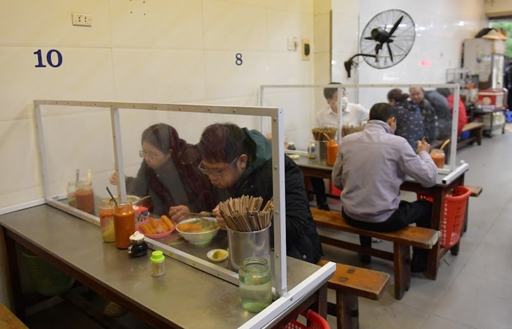 Hanoi restaurants install table partitions to curb COVID-19