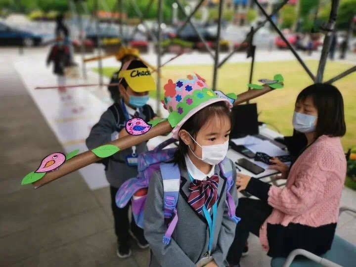 chinese primary students return schools with self made distancing hats