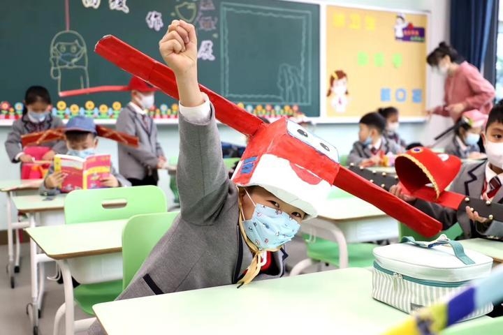 chinese primary students return schools with self made distancing hats