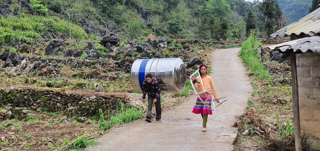 impressive images of upland women carrying giant water tank on back