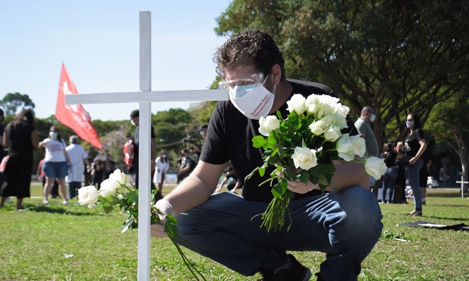 People place flowers to commemorate the death of COVID-19 victims in Sao Paulo, Brazil on June 20
